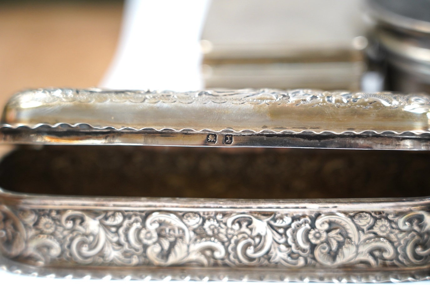 Two late Victorian repousse silver trinket boxes, largest 13.3cm, a pair of George V silver trinket boxes and a tortoiseshell and silver mounted circular trinket box. Condition - poor to fair